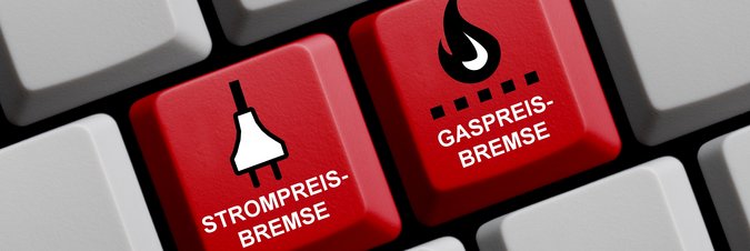 Zwei rote neue Tasten werden auf einer weißen Tastatur hervorgehoben. Darauf steht Gaspreisbremse und Strompreisbremse.