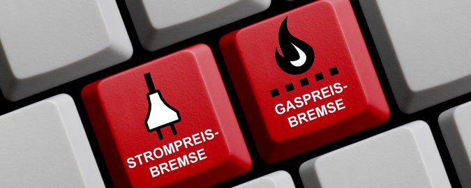 Zwei rote neue Tasten werden auf einer weißen Tastatur hervorgehoben. Darauf steht Gaspreisbremse und Strompreisbremse.